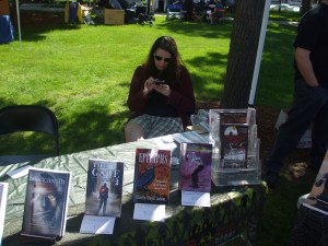 NEHW member Sarah Gomes checking her cellphone during the craft fair. Photo by Jason Harris.