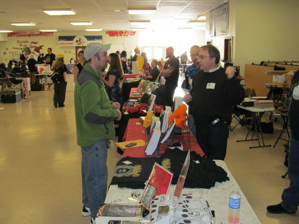 Author T.T. Zuma talks with a visitor to the table. Photo by Jason Harris.