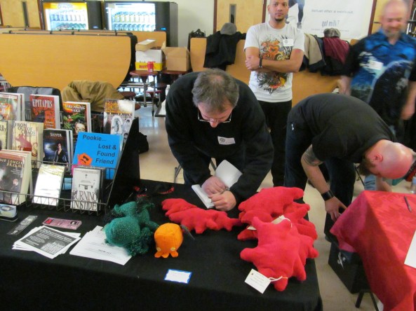 Author T.T. Zuma signing a copy of his book for a fan. Photo by Jason Harris.