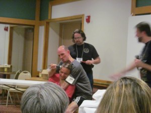 Author P. Gardner Goldsmith having some fun as he shaves some of Rio Youers' head as Author James Moore films it.