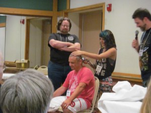 Jeannine Calia finishing shaving author Rio Youers who shaved his head for charity, The Jimmy Fund.
