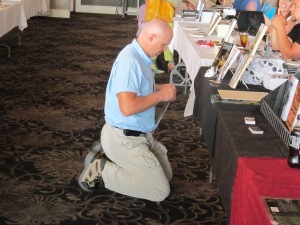 Author Rob Smales setting up his books at the New England Horror Writer table.