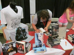 Author Estevan Bagley signing a book for a fan.