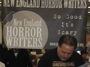 Author Scott Goudsward in front of the New England Horror Writers sign.