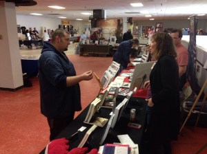 Author Stacey Longo talking with a expo attendee.