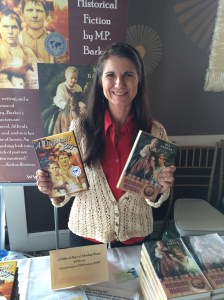 Author M.P. Barker holding her two books, A Difficult Boy and Mending Horses.