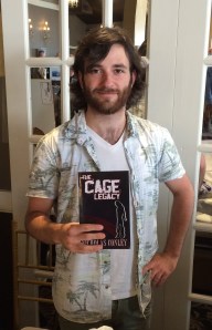 Author Nicholas Conley with his book, The Cage Legacy.