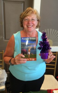 Author Ursula Wong with her book, Purple Trees.