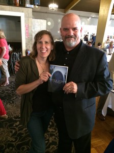Authors Stacey Longo and T. Stephens holding Stephens' book, Dante;s Cypher.