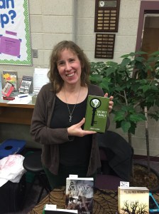 Author Stacey Longo holding her book, Secret Things.