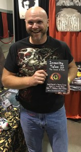 Author Rob Smales holding the new anthology Insanity Tales II from Books & Boos' Press, which contains two of his stories.